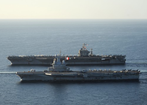 101210-N-1261P-028 ARABIAN SEA (Dec. 10, 2010) The aircraft carrier USS Abraham Lincoln (CVN 72), back, and the French navy aircraft carrier Charles De Gaulle (R 91) are underway together in the Arabian Sea. Abraham Lincoln is deployed to the U.S. 5th Fleet area of responsibility supporting maritime security operations and theater security cooperation efforts in the region. (U.S. Navy photo by Chief Mass Communication Specialist Eric S. Powell/Released)