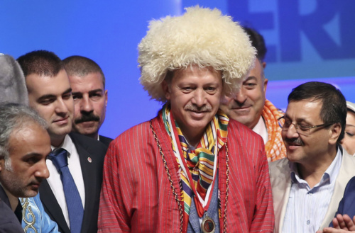 Turkey's Prime Minister and presidential candidate Tayyip Erdogan poses with representatives of nomadic Turkish groups in Ankara August 6, 2014. REUTERS/Stringer (TURKEY - Tags: POLITICS ELECTIONS TPX IMAGES OF THE DAY) - RTR41FZ0